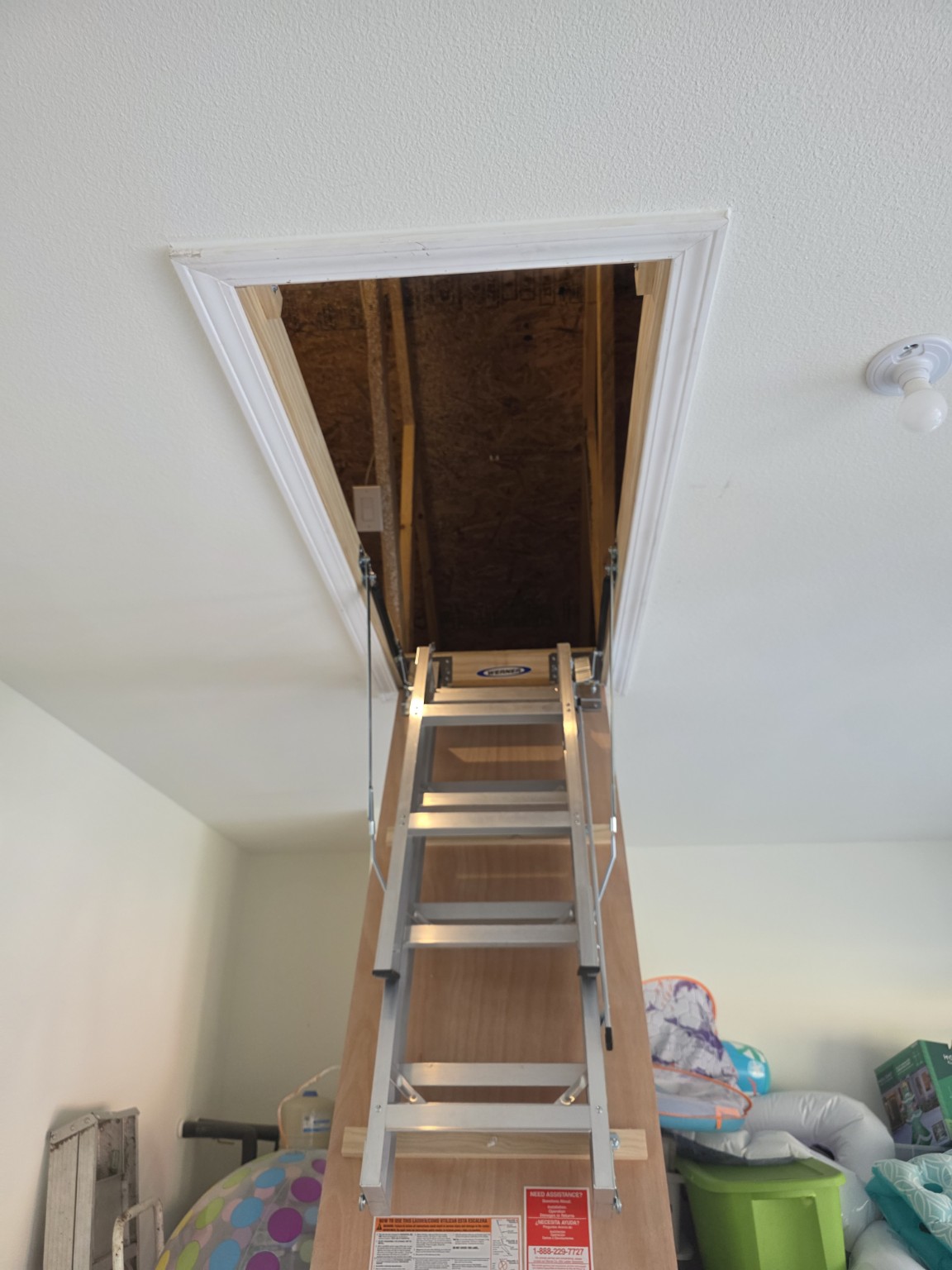 New aluminum attic ladder after installation