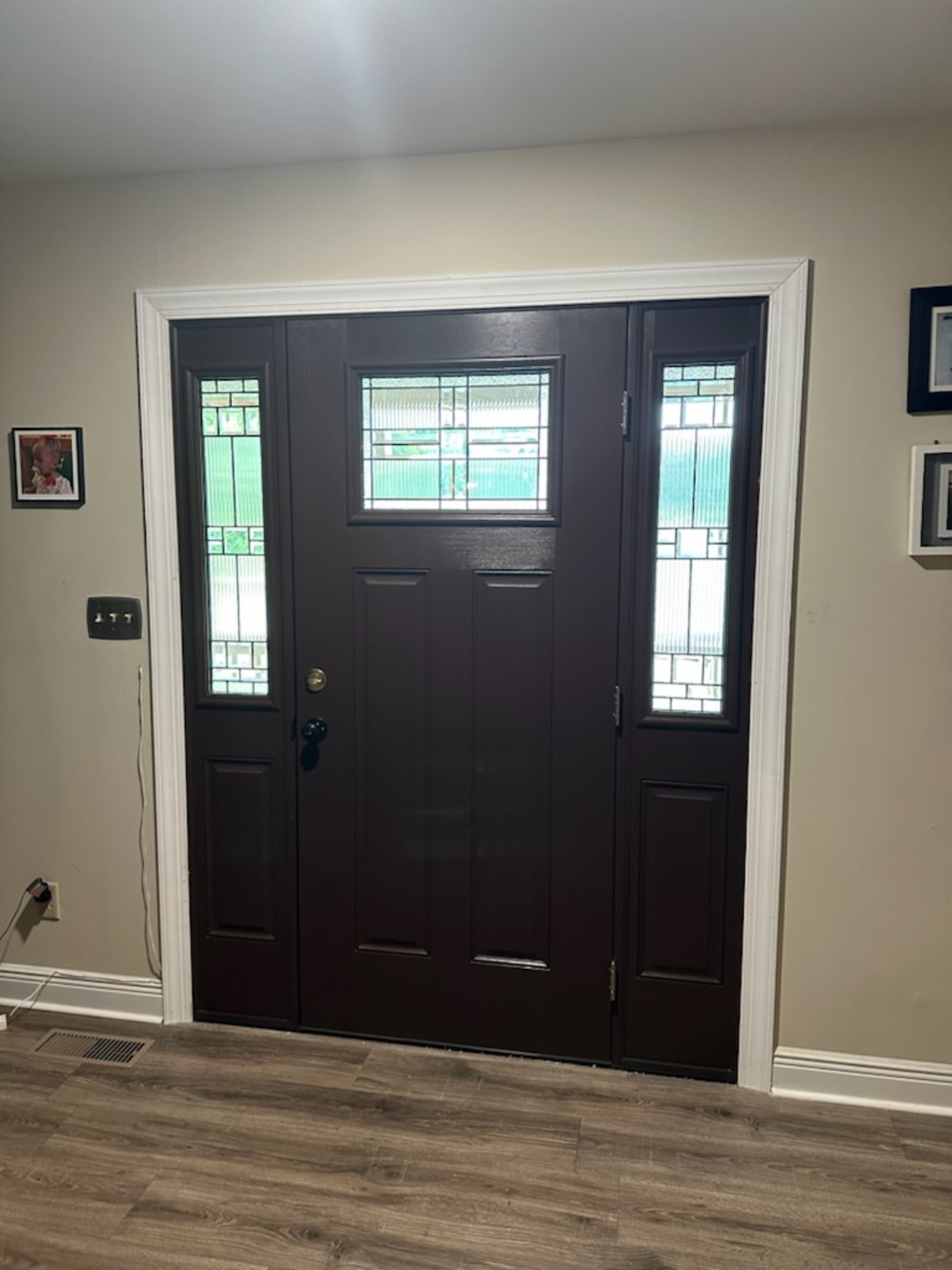 Dark entry door with decorative sidelights